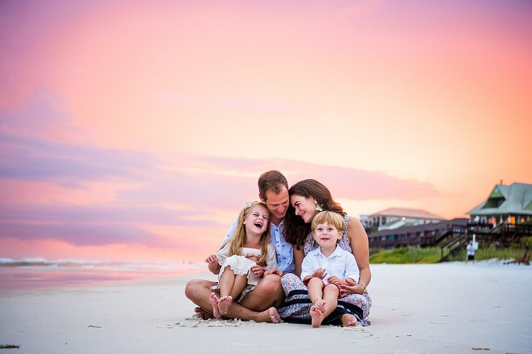 Pink & Purple Skies behind a family of 4 in a Rosemary Beach Session by Rosemary Beach Photographer Two Lights Photography