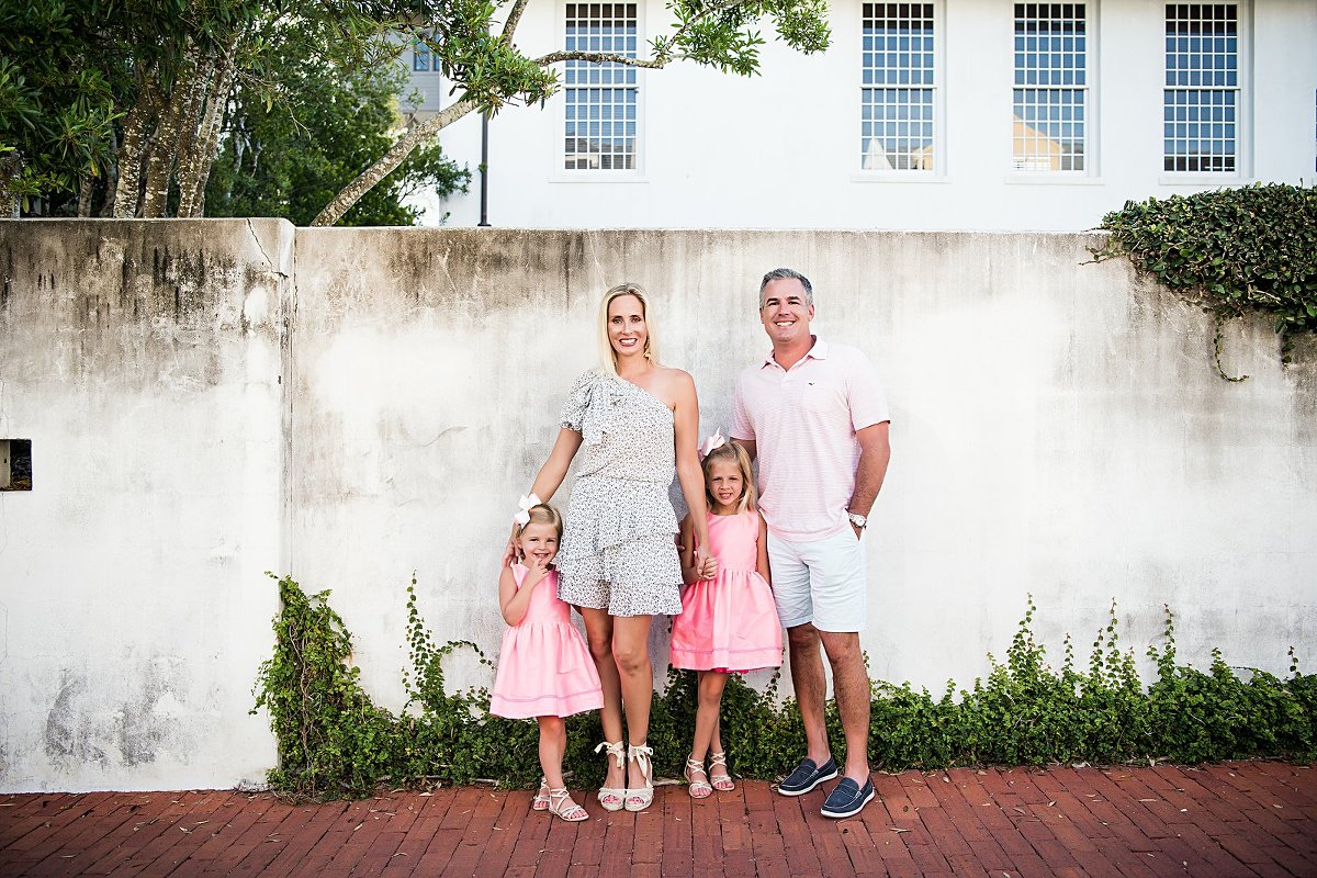family in courtyard of rosemary beach town hall with two lights photography