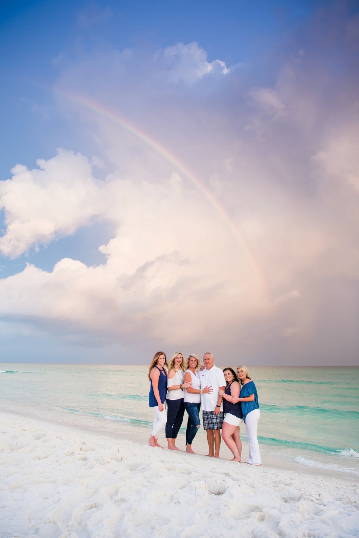 family on a beach with rainbow| two lights photography